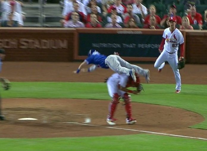 Chris Coghlan jumps over Yadier Molina