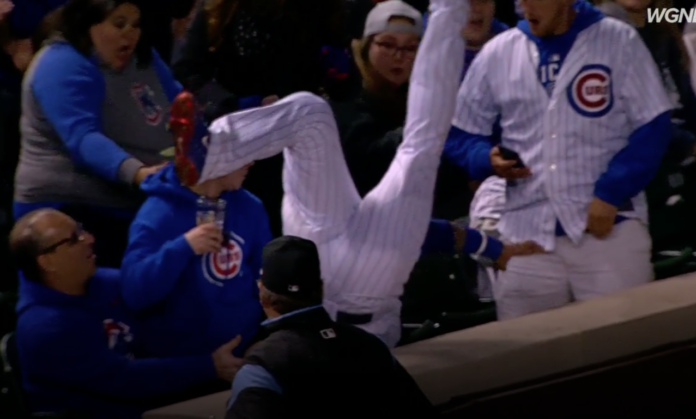 Javier Baez tumbles into stands